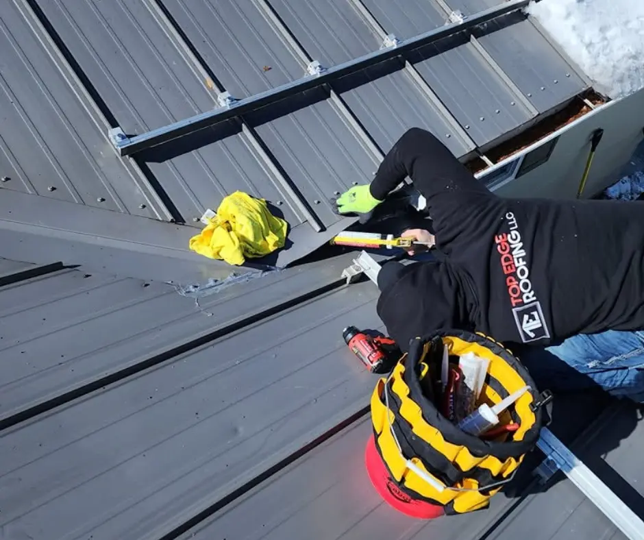 Roofing contractor inspecting storm and hail damage for an insurance claim in Bozeman, MT