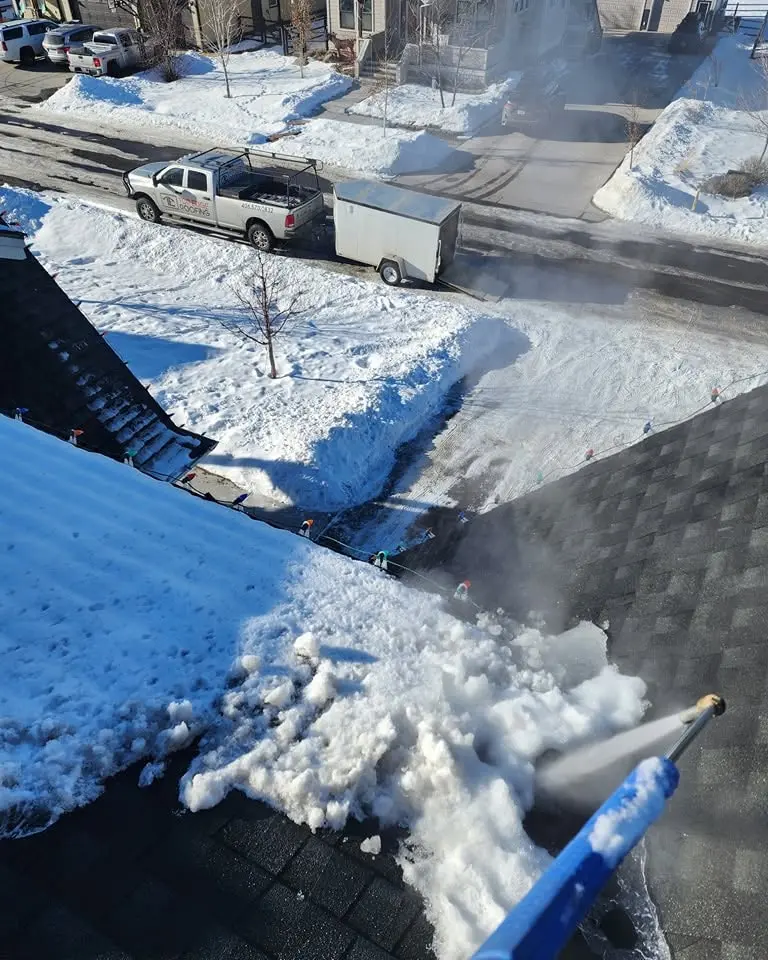 snow removal in bozeman looking down at ground from the roof level